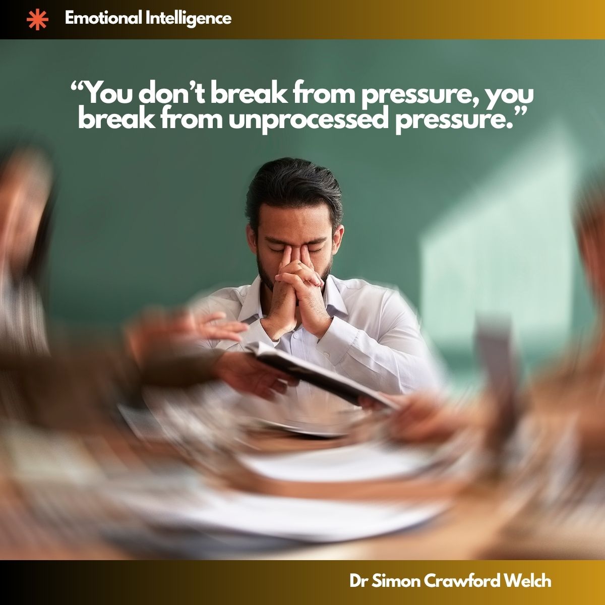 Quote "You don't break from pressure, you break from unprocessed pressure." By Dr. Simon Crawford Welch. A man in a crisp white button down shirt sits at a desk inside an office or classroom, eyes closed, pressing both hands together against the bridge of his nose in a moment of quiet stillness. A green chalkboard fills the background. Around him, papers and documents fly past in a circular blur of motion, creating a swirling vortex of activity that frames his calm center. The contrast between external chaos and internal processing. The image illustrates the moment a person stops to feel and metabolize stress instead of pushing through it, capturing the quiet pause that prevents collapse.