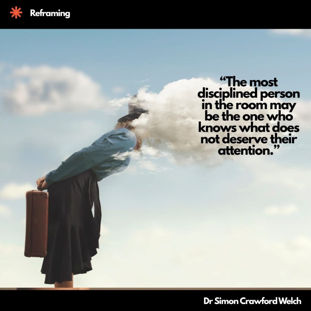 A woman in a blue blouse and dark skirt, holding a brown vintage suitcase behind her, leans forward with her head disappearing into a soft white cloud against a pale blue sky, with a Reframing label in the top corner. The image represents a mind lost in noise, and the discipline it takes to choose what deserves attention. Quote over the image reads: "The most disciplined person in the room may be the one who knows what does not deserve their attention." By Dr. Simon Crawford Welch.